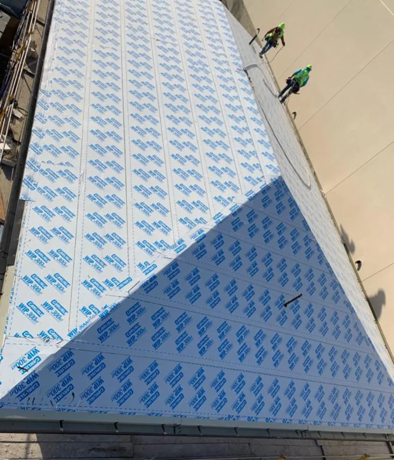 Professional roofers installing underlayment on a metal roof in Frankenmuth